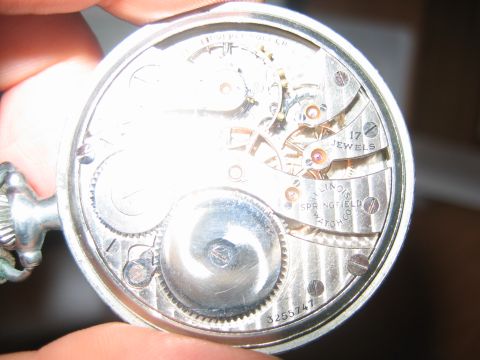 1992 Ford Bronco - Close-up view of a pocket watch's internal mechanism, showing gears and jewels.