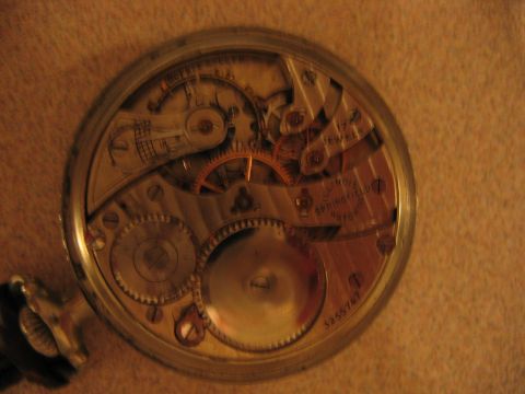 1992 Ford Bronco - Close-up of a pocket watch's internal mechanism, showing intricate gears and the '17 JEWEL' marking.