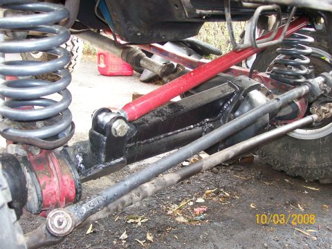 1984 Ford Bronco - Close-up view of a vehicle's modified suspension system, showing heavy-duty components.