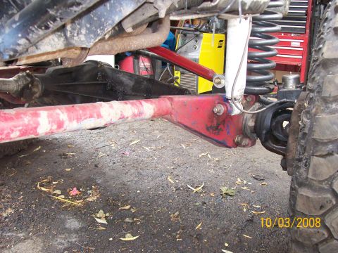1984 Ford Bronco - Modified suspension components are visible in this close-up view of a vehicle's undercarriage.