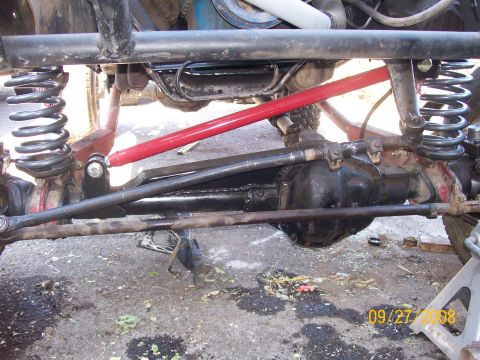 1984 Ford Bronco - This image shows a close-up view of a vehicle's front axle and suspension system, aftermarket modifications.