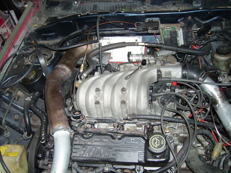 3.0 V6 engine bay with cast aluminum intake manifold and custom heat-stained tubing