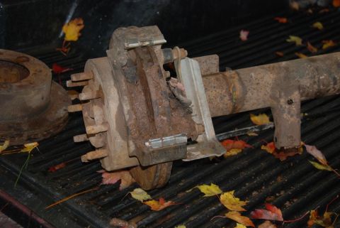 1996 Ford Bronco - Close-up of a rusty rear axle assembly, likely from a truck or SUV, with brake components visible.