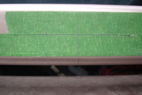 1996 Ford Bronco - Close-up of green masking tape applied to a car's body panel, marked with pencil lines.