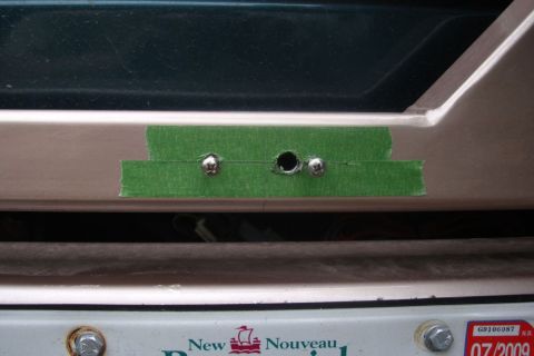 1996 Ford Bronco - Drilled holes for license plate light mounting, covered with green tape.