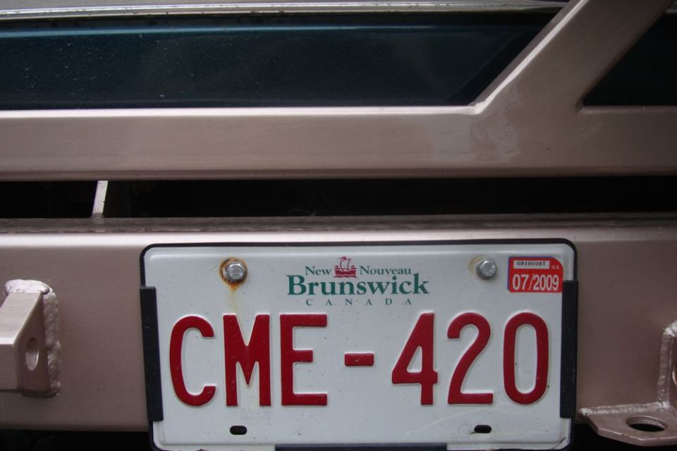 New Brunswick license plate CME-420 with 07/2009 sticker on a vehicle's rear bumper