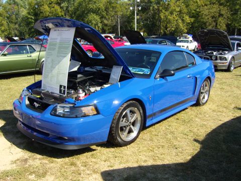 2007 Ford Mustang - A blue 2003 Ford Mustang coupe is displayed with its hood open, revealing a document detailing its specifications.
