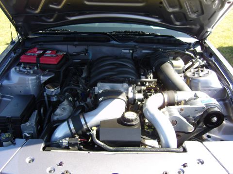 2007 Ford Mustang - Engine bay view showing a supercharged V8 engine with various components.