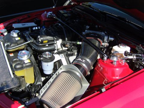 2007 Ford Mustang - Close-up of a modified engine bay, an aftermarket cold air intake system and custom components.