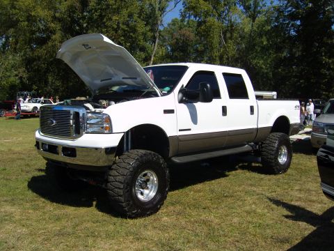 2007 Ford Mustang - This lifted Ford F-250 Super Duty pickup truck is displayed with its hood open, revealing the engine bay.