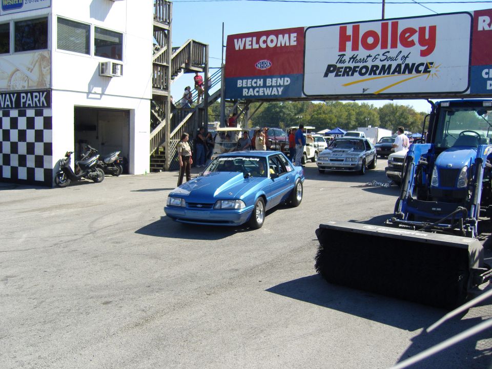 Blue fox body Mustang with hood scoop on track