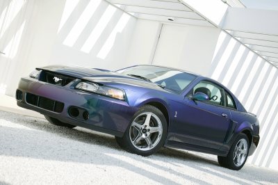 2004 Ford Mustang - A 2004 Ford Mustang coupe with a Mystichrome paint finish is shown in a three-quarter front view.