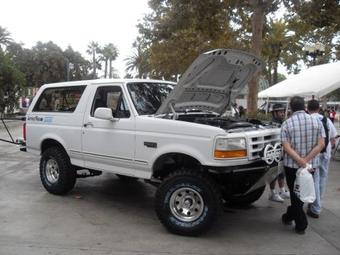 1990 Ford Bronco - White Ford Bronco with hood open, parked outdoors. Appears to be from the early 1990s.