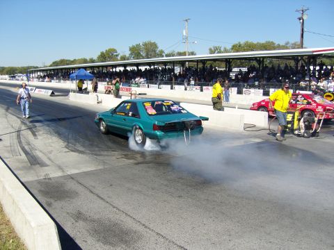 2007 Ford Mustang - Drag racing car performs a burnout on the track before a race.