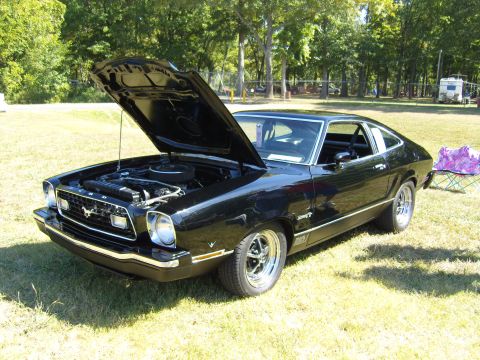 2007 Ford Mustang - This black Ford Mustang II has its hood open, revealing the engine bay.