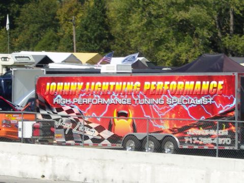 2007 Ford Mustang - A trailer for a performance tuning specialist is parked at an outdoor event.