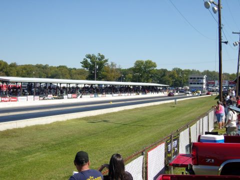 2007 Ford Mustang - Spectators watch a drag race on a sunny day at the track.