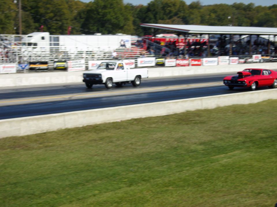 Photo of two drag cars racing down a track