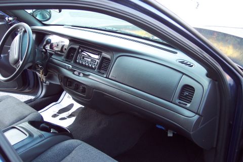 2001 Ford Crown Victoria - Interior view of a 2001 Ford Crown Victoria, focusing on the dashboard and driver's seat area.