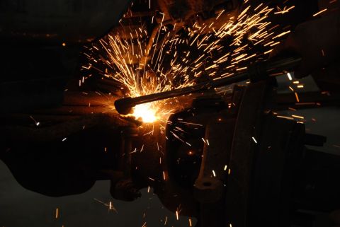 1996 Ford Bronco - A close-up view of a welding torch in action, illuminating the darkness with a cascade of bright sparks.