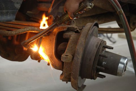 1996 Ford Bronco - Cutting a rusty suspension part with a torch.