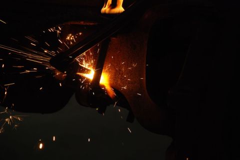 1996 Ford Bronco - Bright orange sparks fly from metal being welded in the dark.