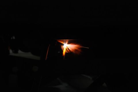 1996 Ford Bronco - A close-up view of a welding torch emitting bright sparks and orange flame against a dark background.