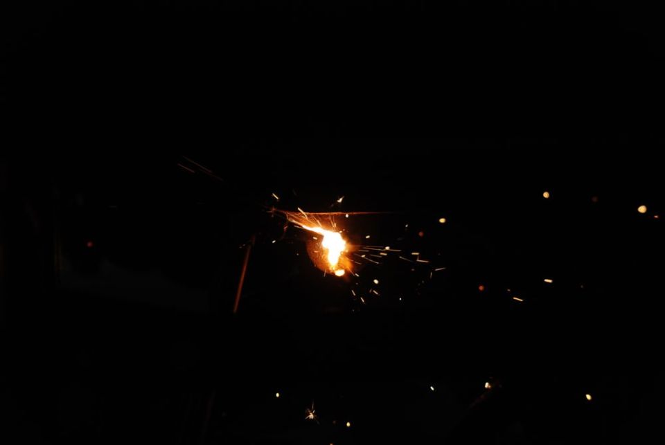 welding sparks flying in the dark