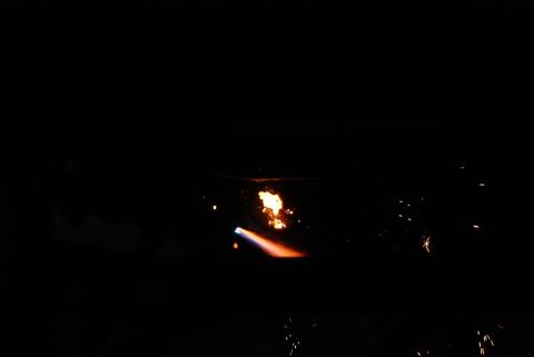 1996 Ford Bronco - A welding torch illuminates the darkness with a bright flame and scattered sparks.