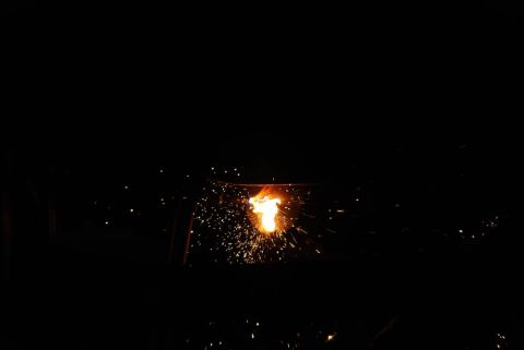 1996 Ford Bronco - A close-up view of intense welding sparks illuminating the darkness.