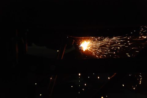 1996 Ford Bronco - A close-up view of bright welding sparks illuminating the darkness.
