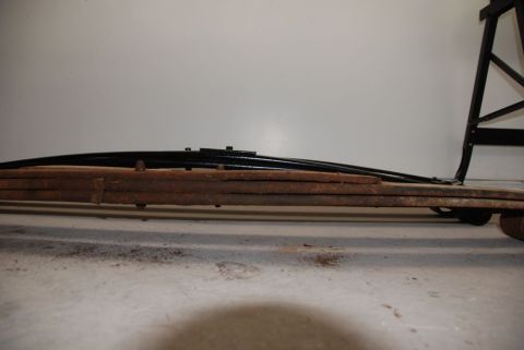 1996 Ford Bronco - A close-up view of a vehicle's leaf spring assembly, showing both old and new components.
