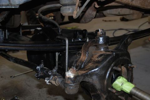 1996 Ford Bronco - Close-up view of the suspension and steering linkage on a vehicle's undercarriage.