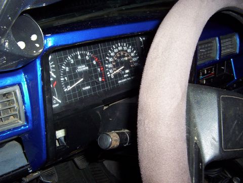 1986 Toyota Hilux - The interior of a 1986 Toyota Hilux displays its dashboard gauges, including a tachometer and speedometer.