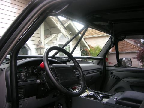 1996 Ford Bronco - Interior view of a 1996 Ford Bronco, showing the dashboard and roll cage.