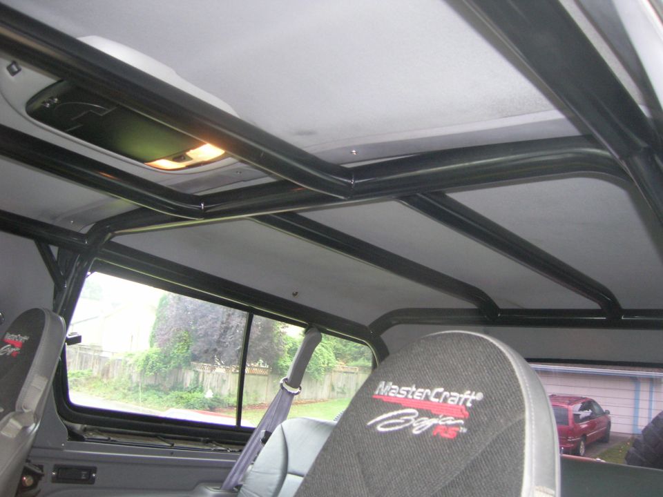 Black roll cage inside SUV hardtop with gray MasterCraft Baja RS racing seat