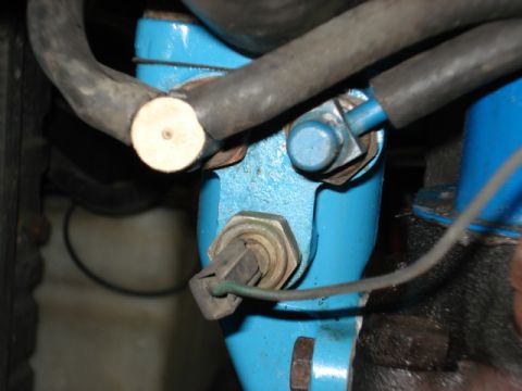 1979 Chevrolet C/K Pickup - Close-up of an engine component with visible hoses and wiring.