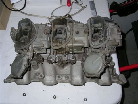 1972 Ford Ranchero - Triple carburetor intake manifold assembly shown on a workbench.