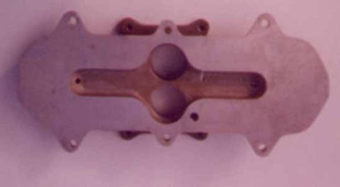 1972 Ford Ranchero - This is a close-up view of an automotive part, possibly an intake manifold, with a distinctive shape and openings.