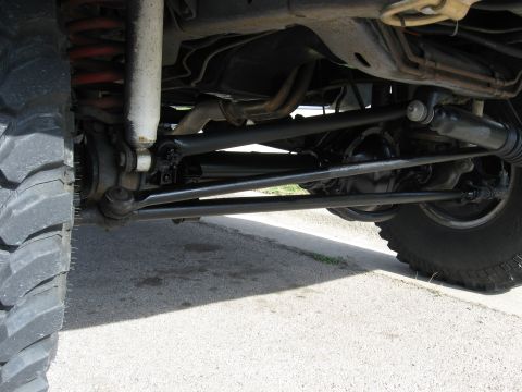 1979 Ford Bronco - Close-up view of the vehicle's undercarriage, highlighting the suspension and steering system.