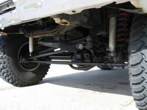 1979 Ford Bronco - A close-up view of the undercarriage reveals the complex suspension and steering systems of the vehicle.