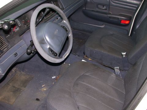 2000 Ford Crown Victoria - The interior of a 2000 Ford Crown Victoria, the dashboard, steering wheel, and front seats.