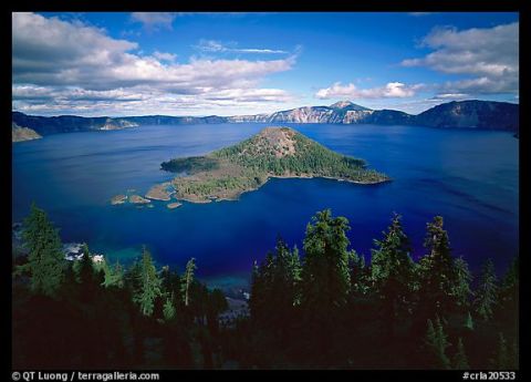 1974 Ford Ranchero - A scenic view of Crater Lake, Wizard Island and surrounding mountains under a cloudy sky.