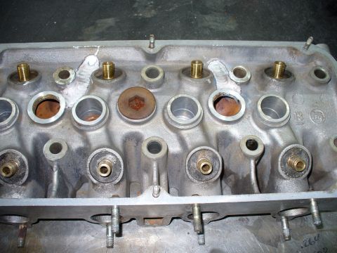 1971 Toyota Corolla - Close-up of an engine cylinder head, showing various ports and brass fittings.