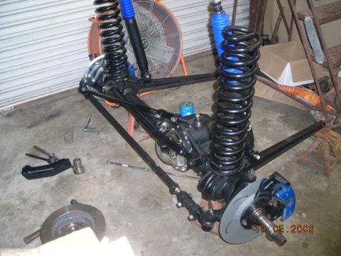 1993 Ford Bronco - Front suspension assembly with blue shocks and disc brakes, likely for an off-road vehicle.