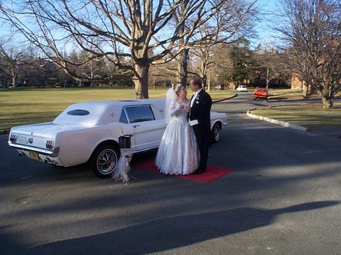 2001 Ford Mustang - Wedding couple poses with a vintage white limousine on a sunny day.