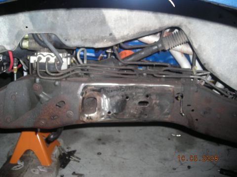 1993 Ford Bronco - Underside view of a vehicle's frame and suspension system, showing various hoses and mechanical parts.