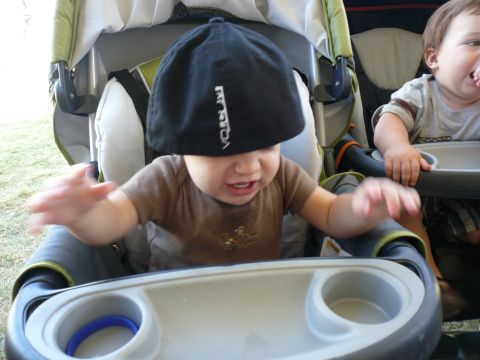1996 Ford Probe - Two babies are seated in a double stroller, one wearing a black cap and the other reaching out.