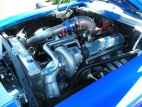 1998 Ford Crown Victoria - The engine bay features a prominent turbocharger and custom exhaust system, indicating significant modifications.