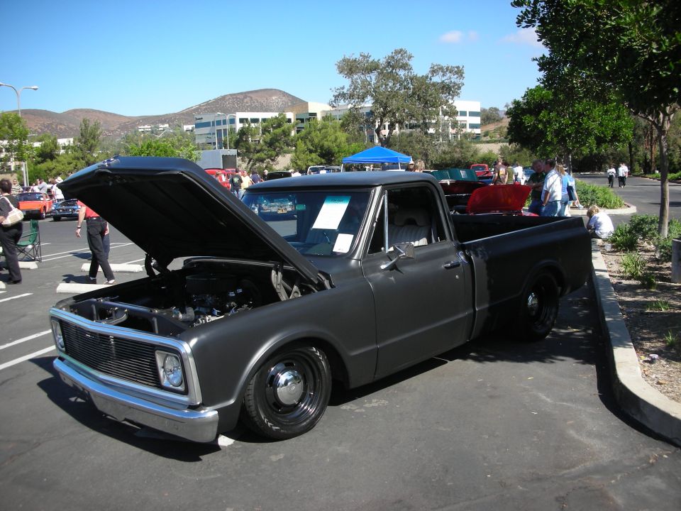 Gray classic pickup truck with hood open, parked outside